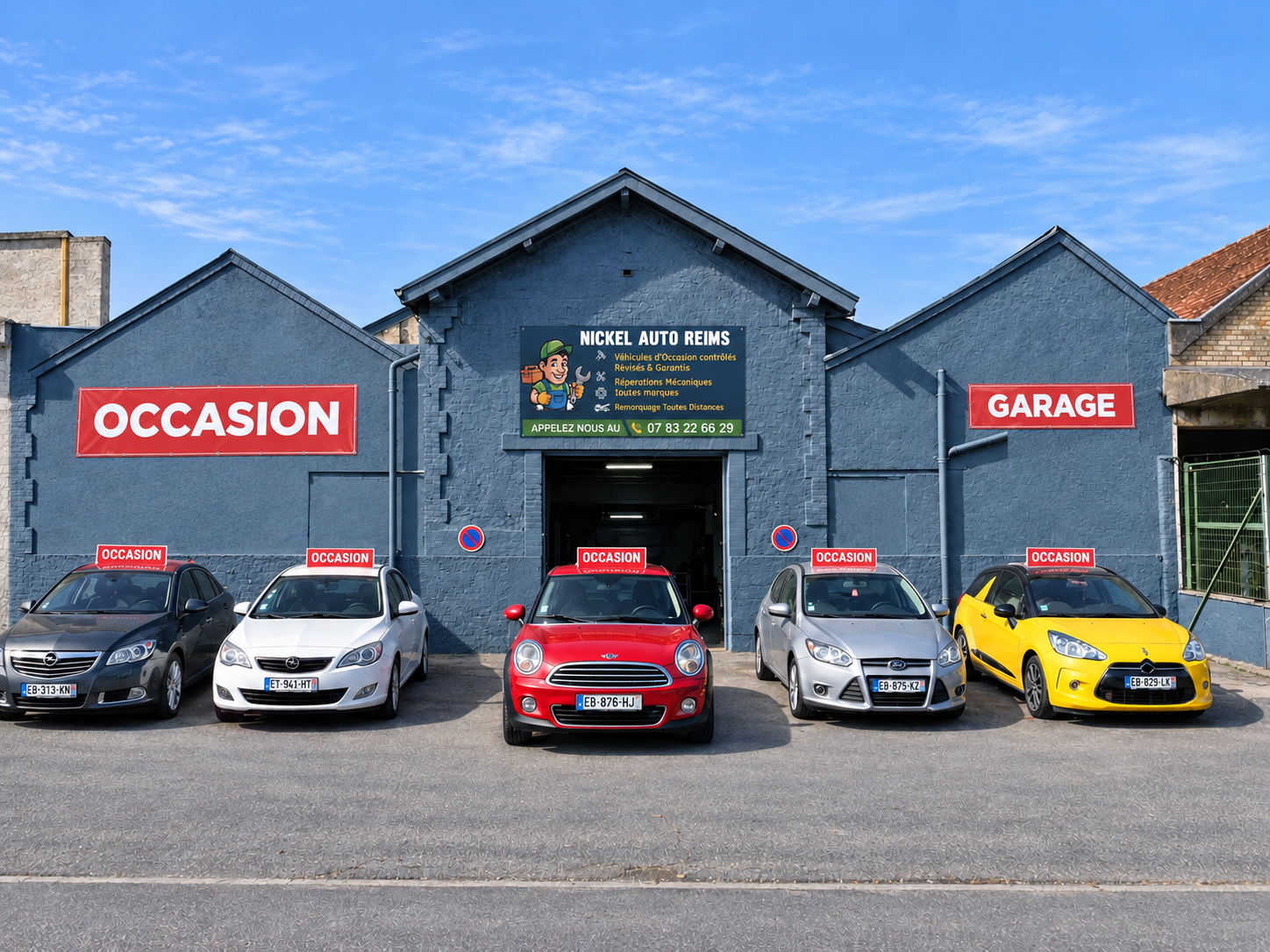 Façade retouchée de Nickel Auto Reims avec les panneaux Occasion et Garage